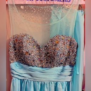Formal light blue beaded gown with a shawl.